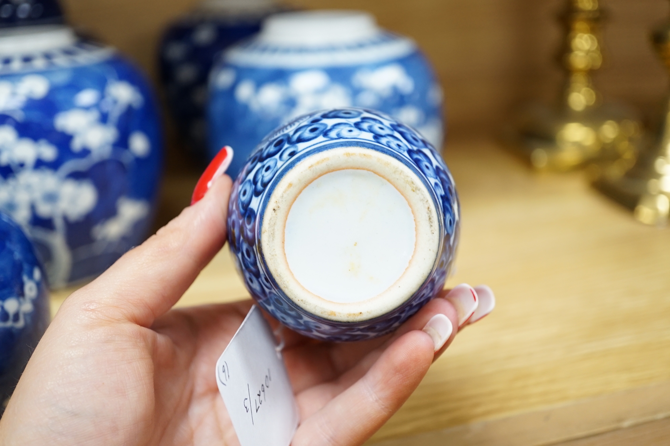 Five Chinese blue and white prunus ginger jars, one with cover- 15cm high and another jar